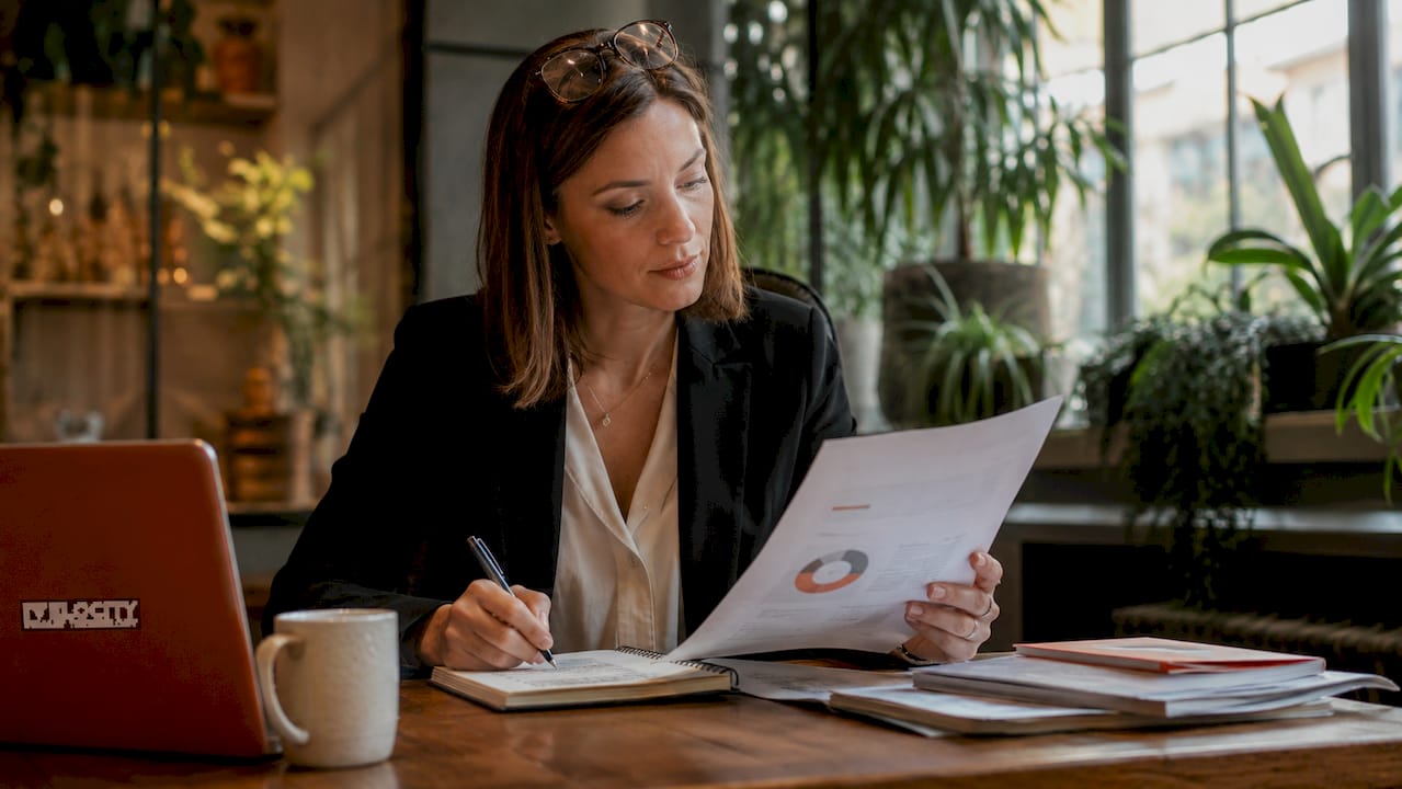 Professional woman reviewing employee wellbeing brochure