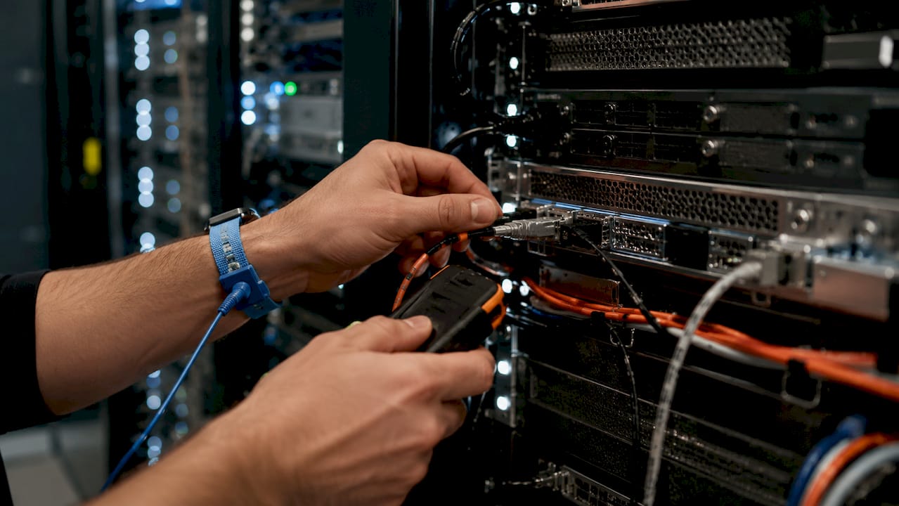 Technician hands configuring BMC hardware panel