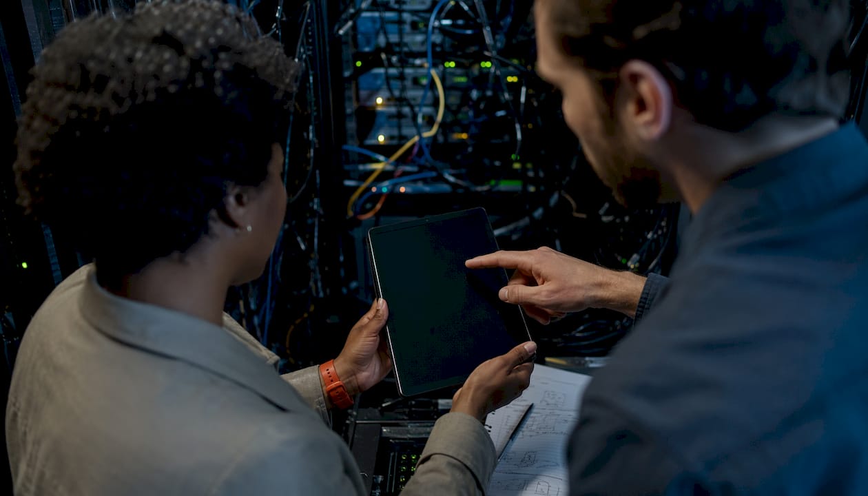 Hands configuring device in server room setup