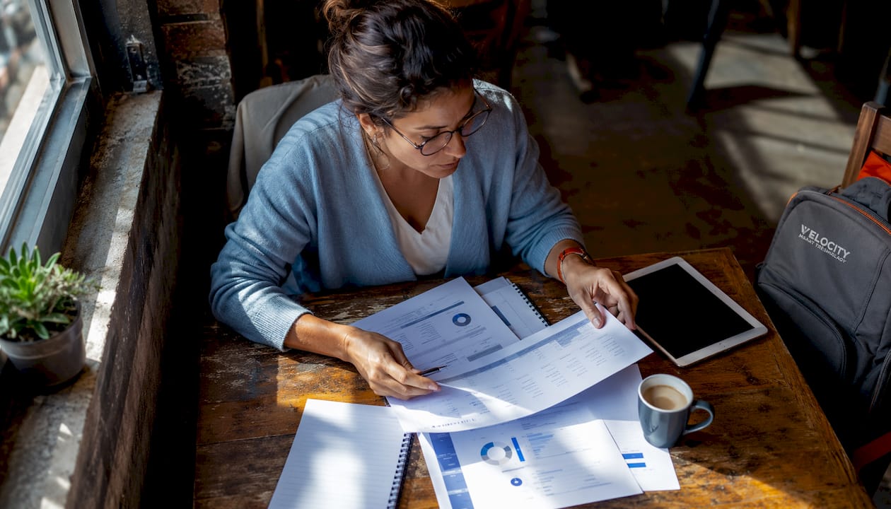 IT manager reviewing printed ticket reports