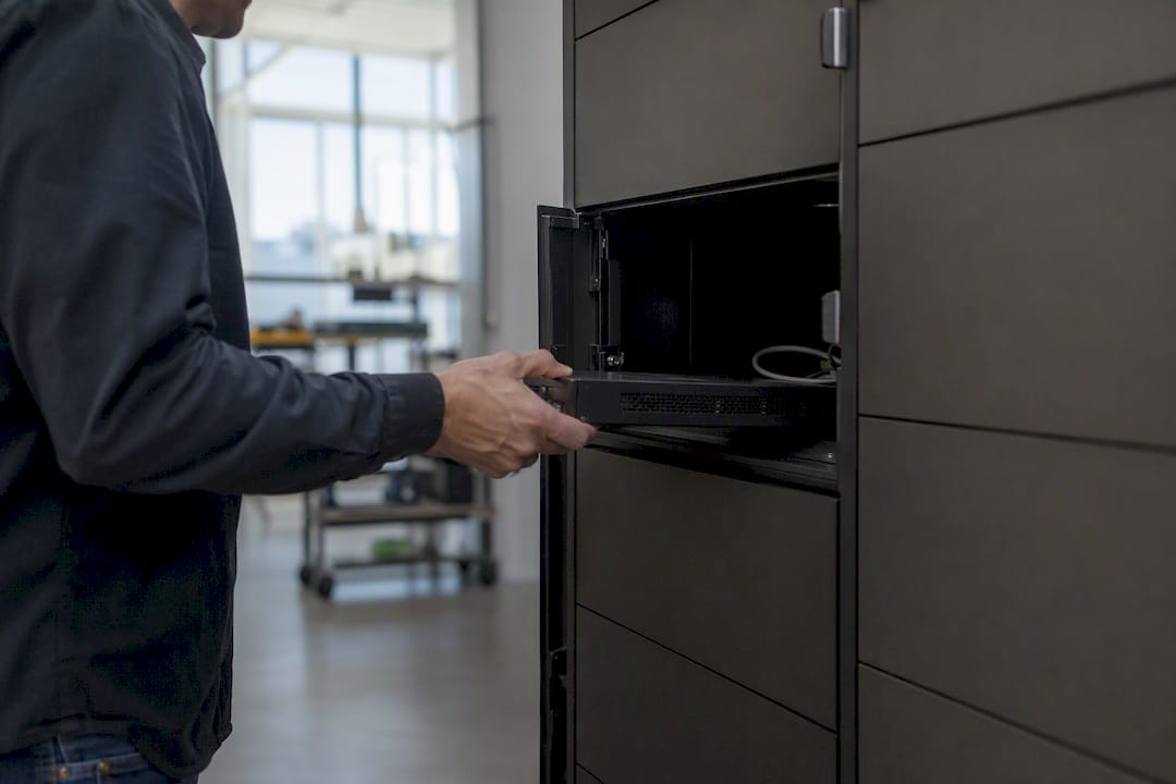 Hands placing device detail into IT locker