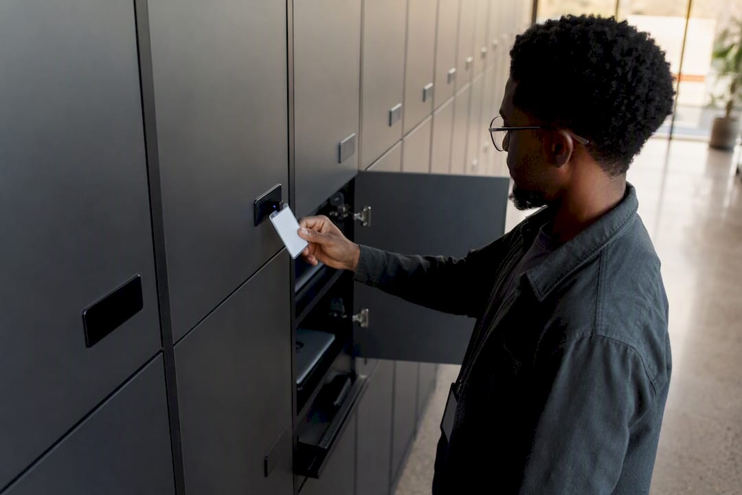 Hands scanning badge to unlock IT locker