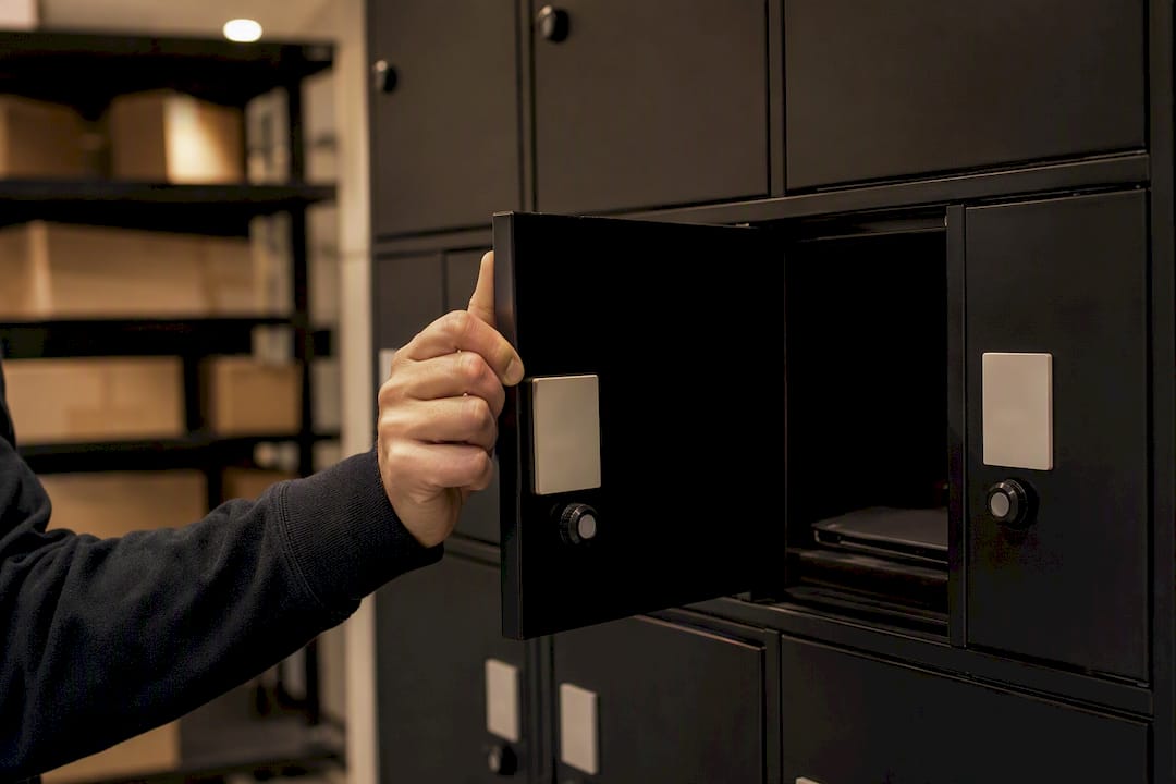 Hand opening IT locker door at night
