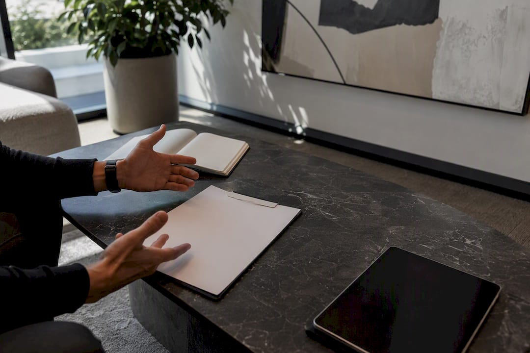 Hands discussing contract over table