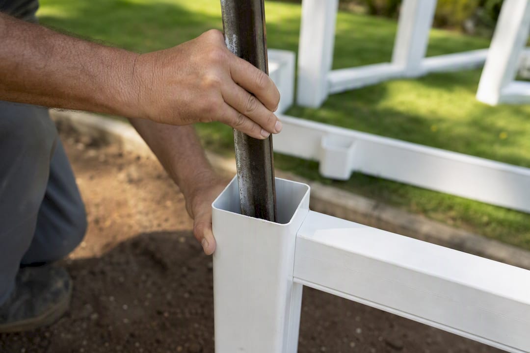 Inserting metal reinforcement in vinyl fence post