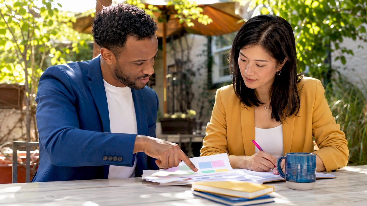 Small business owners reviewing marketing reports
