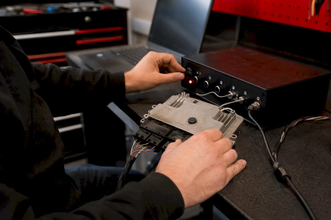 Technician testing airbag ECU on bench