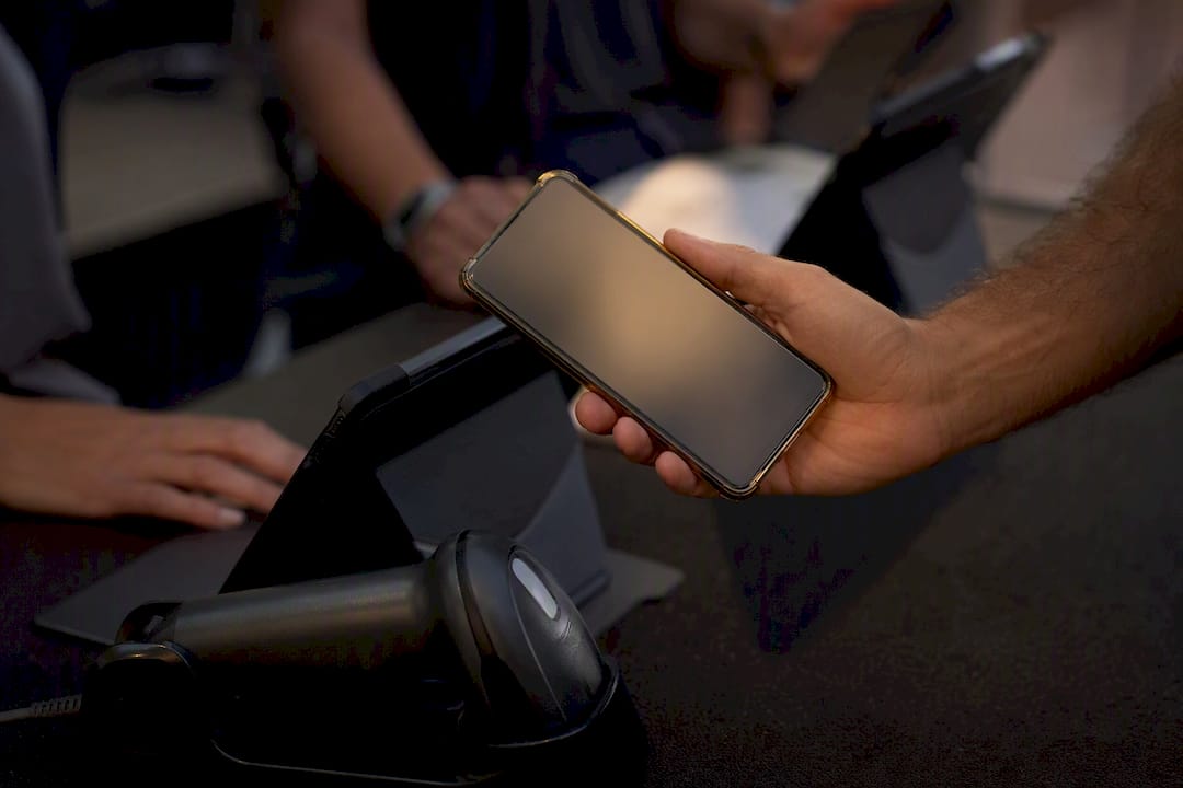 Hand adjusting smartphone angle for QR scanning