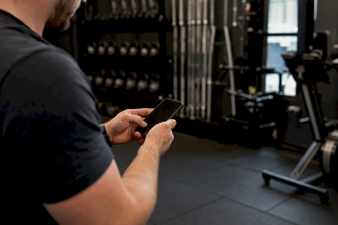 Coach holding smartphone with dark screen
