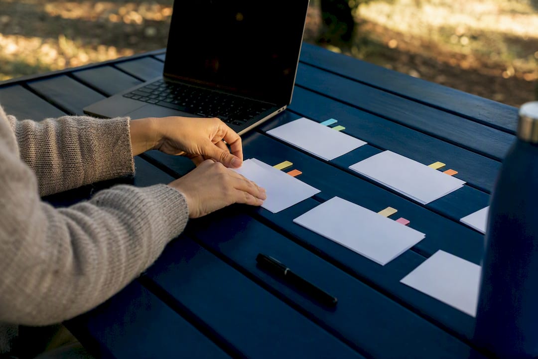 Hands organizing client approval materials