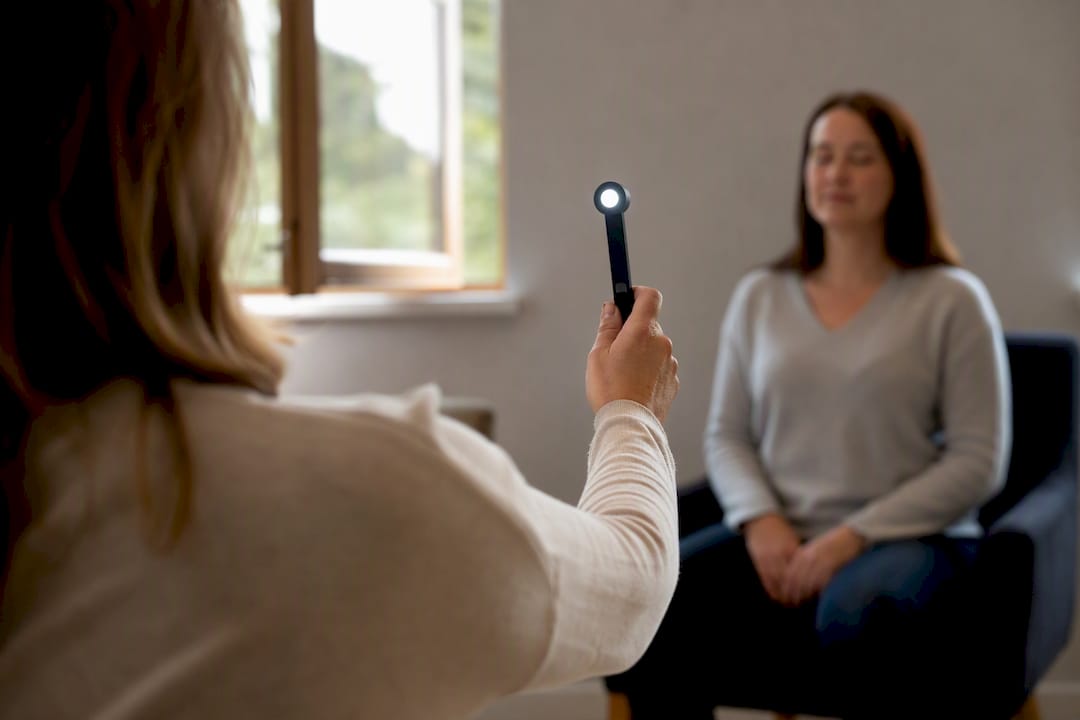 Therapist guiding eye movement in EMDR therapy