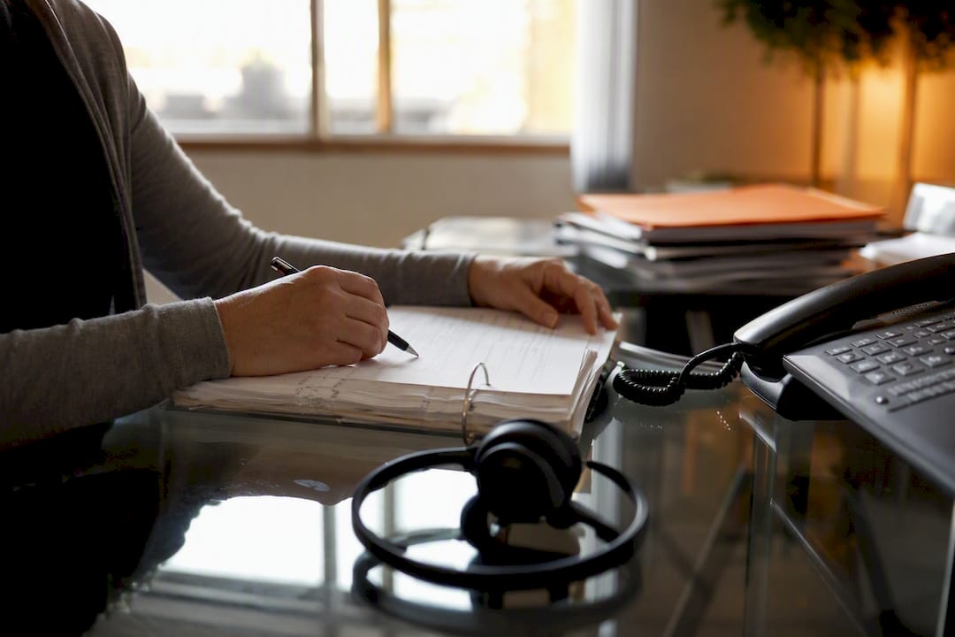 Scheduler hands arranging shift roster on desk