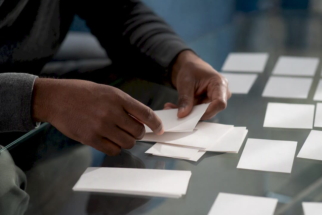 Hands sorting blank abstract review cards