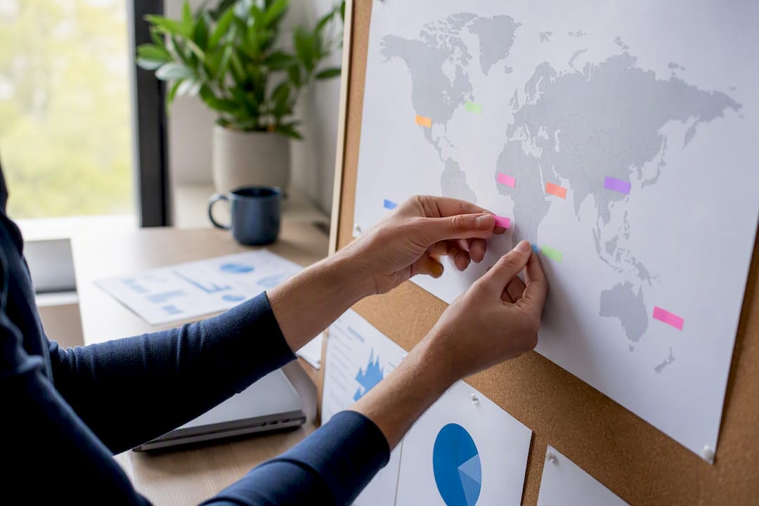 Hands weighting country data on world map