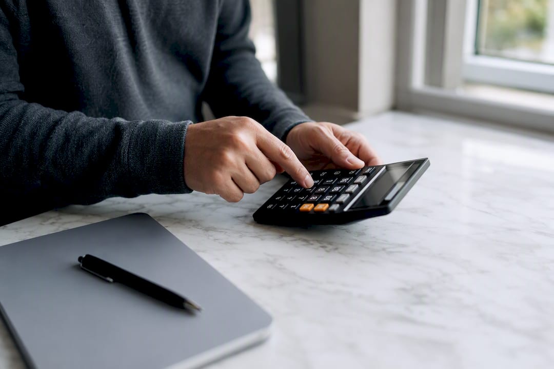 Hands calculating pricing with calculator