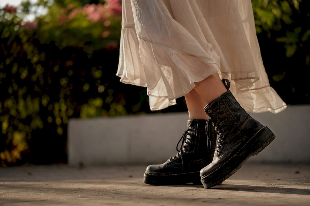 Contrast of rugged boots with soft flowy clothing