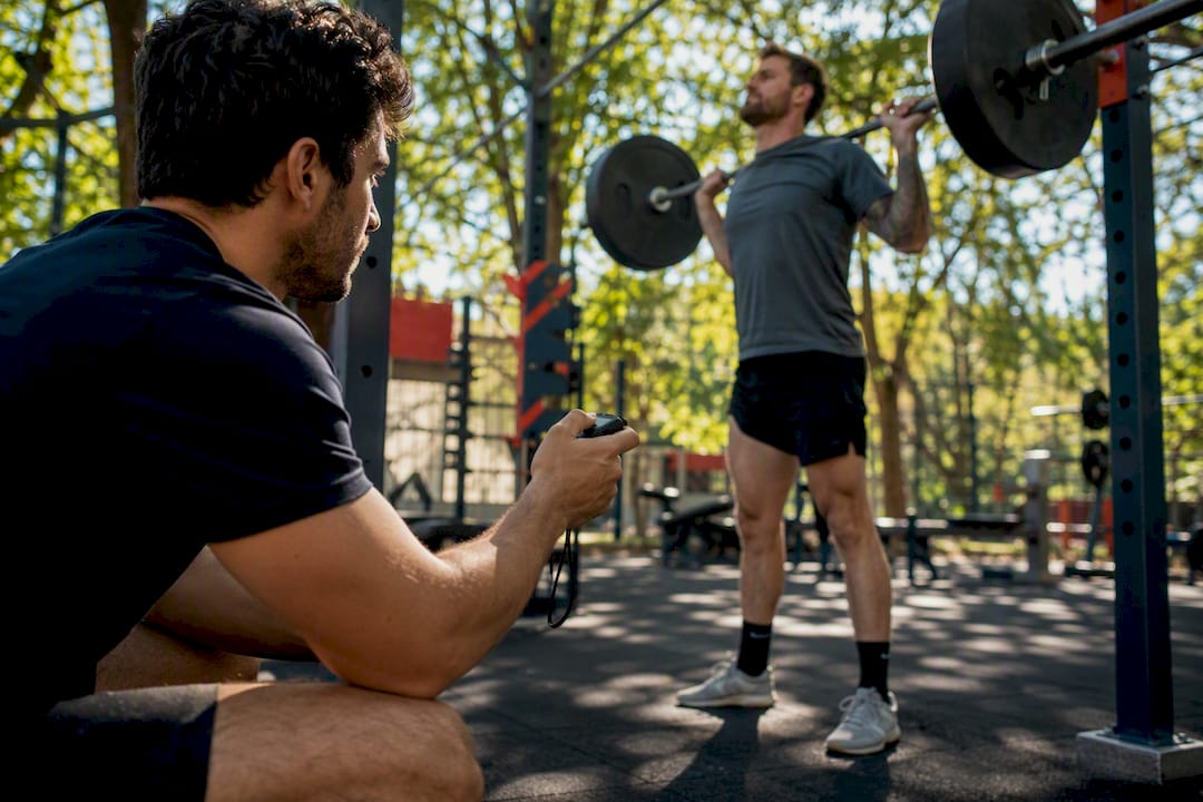 Coach timing barbell velocity loss with stopwatch