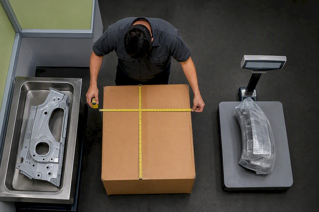 Technician measuring packaged automotive component