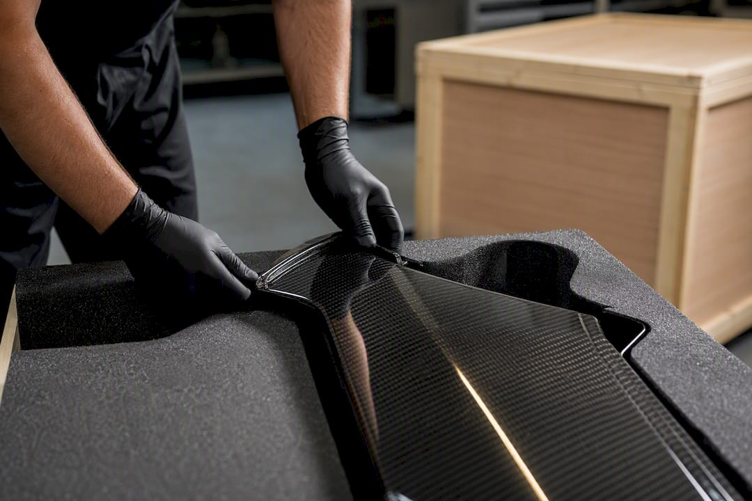 Carbon fiber panel secured in foam packaging