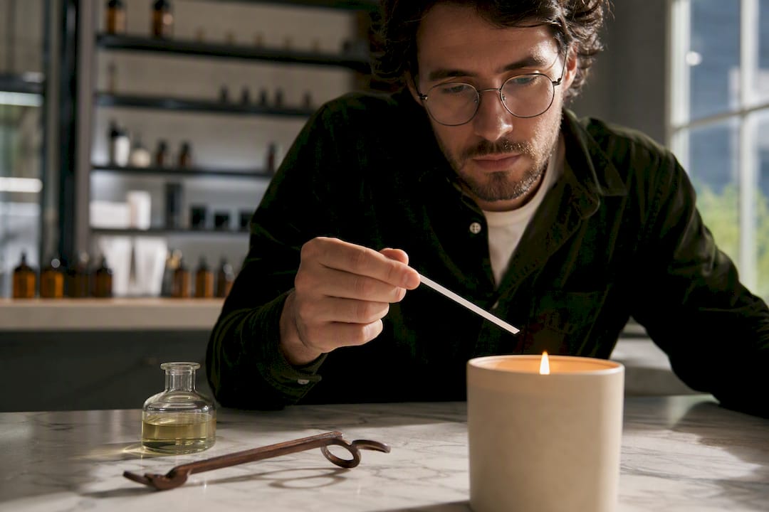 Tester evaluating candle scent near flame