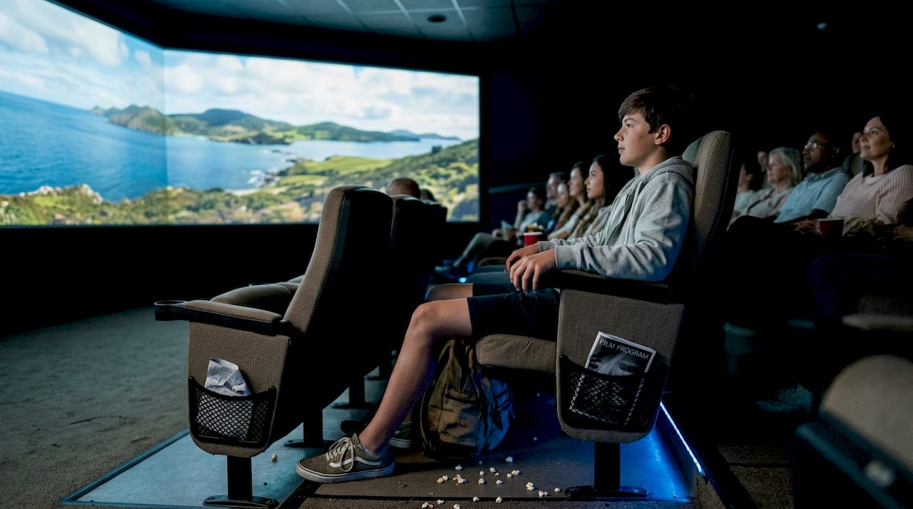 Teen viewing immersive Hawaii theater display