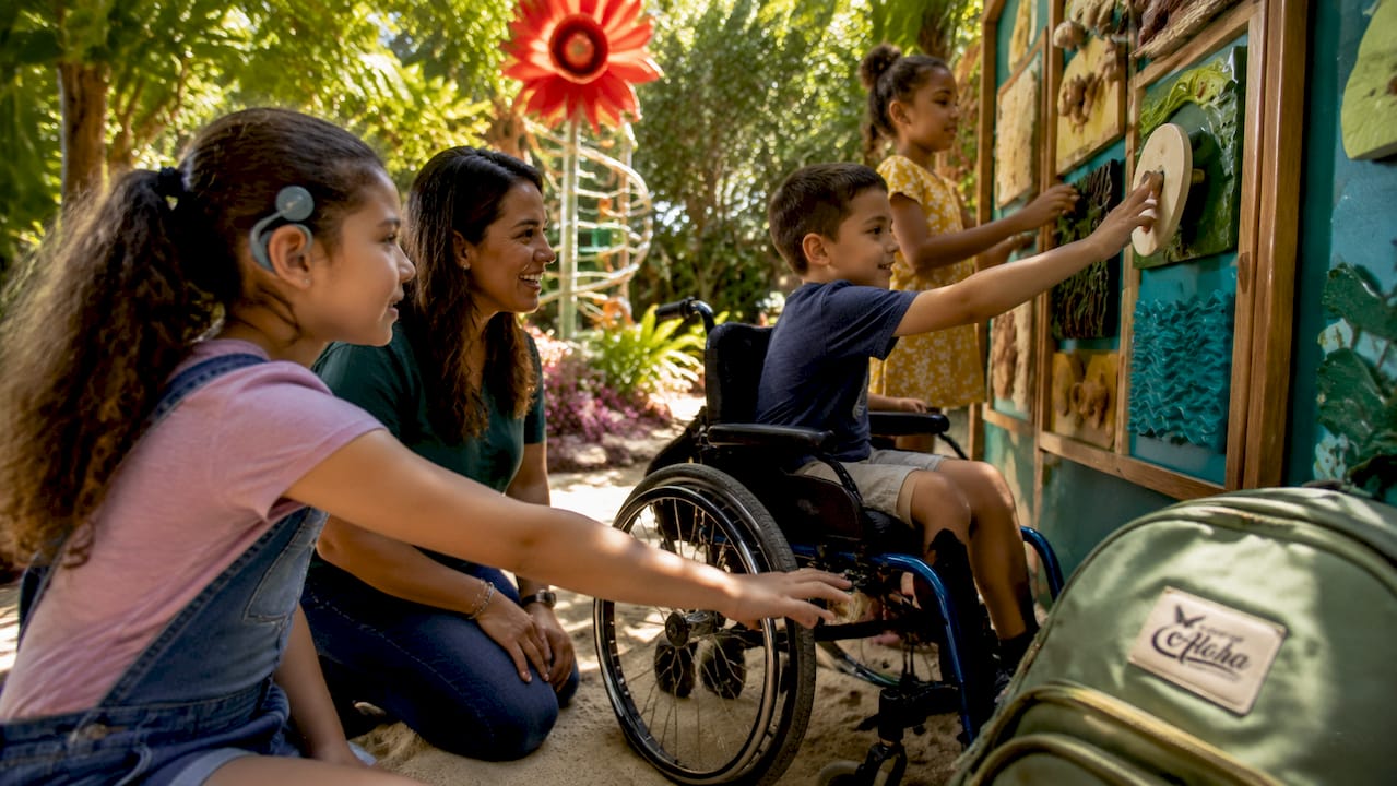 Educator guiding children at sensory exhibit