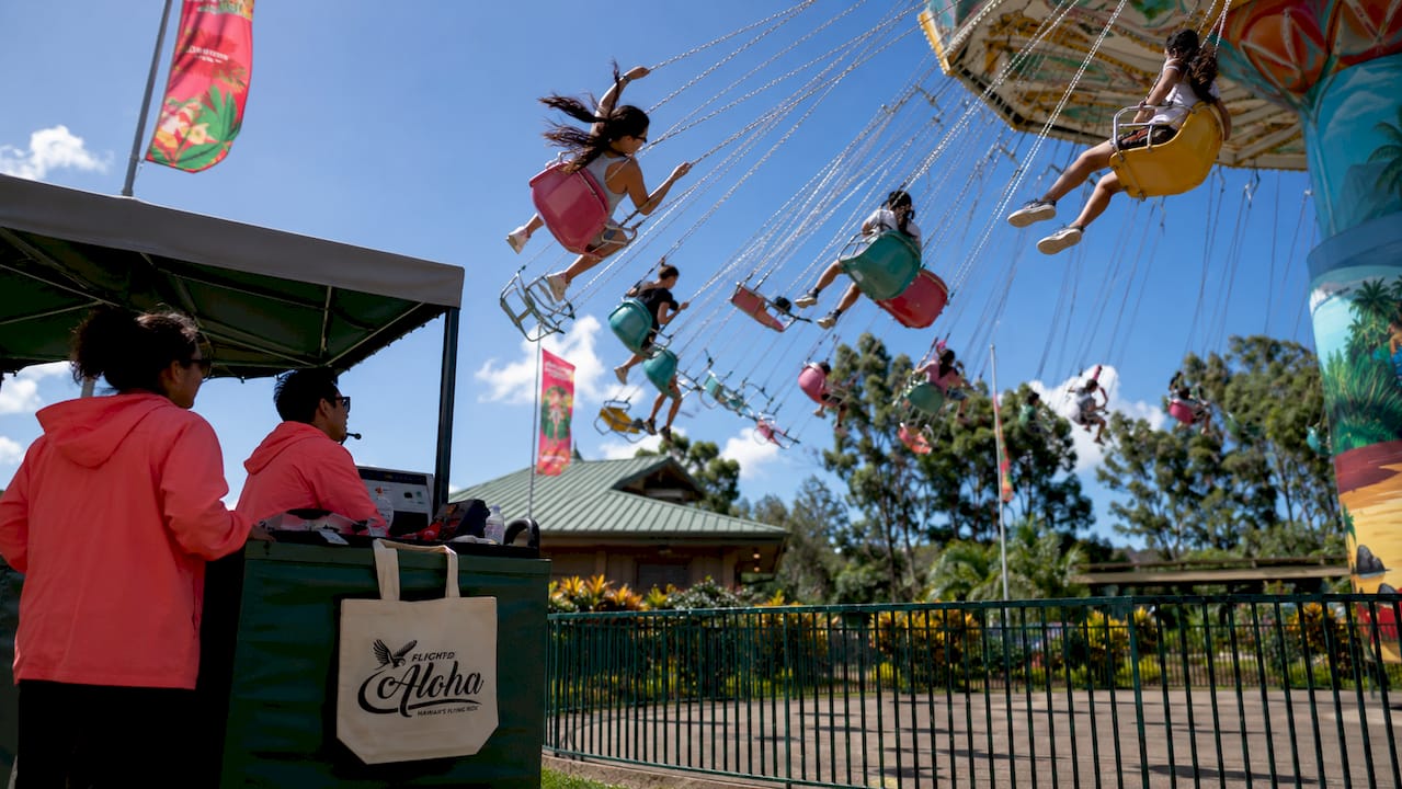 Swing ride in motion during a windy day at amusement park