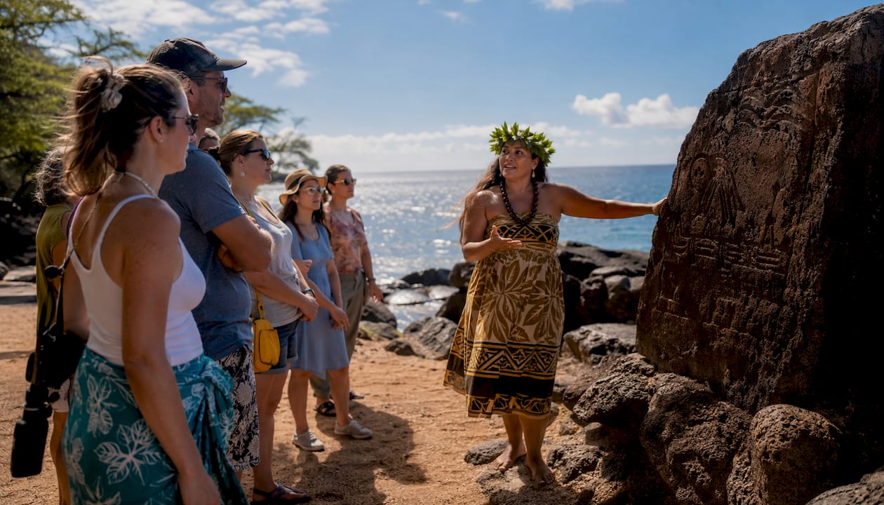 Cultural guide telling Hawaiian stories to tourists