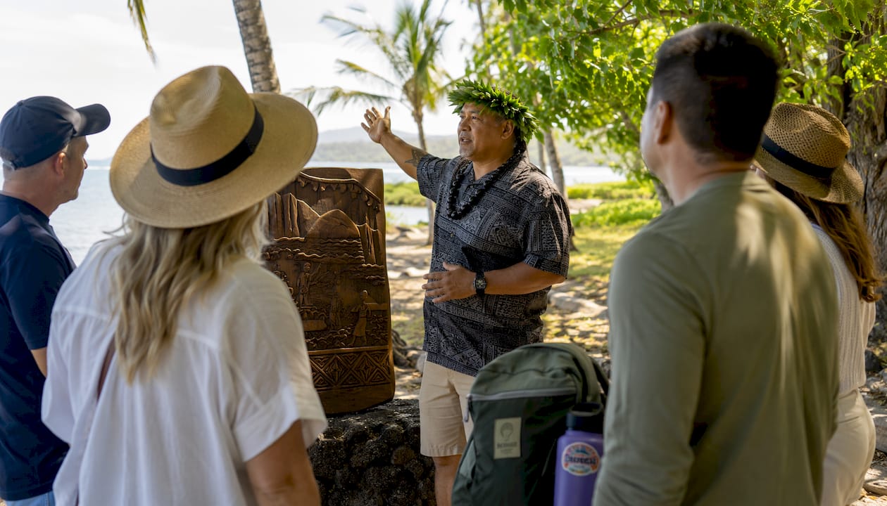 Tour guide showing cultural site near Kailua Pier