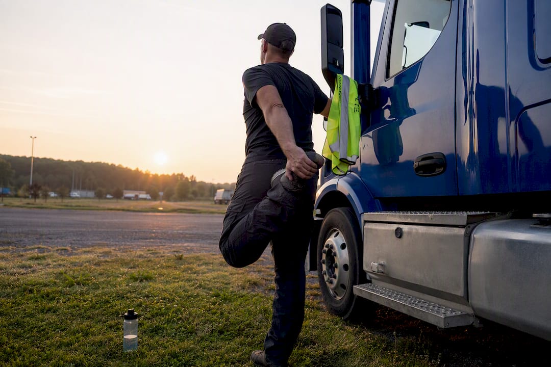 Truck driver stretching at rest stop outdoors