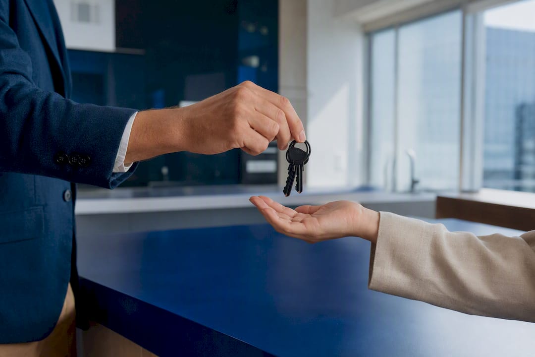 Hands exchanging house keys in negotiation