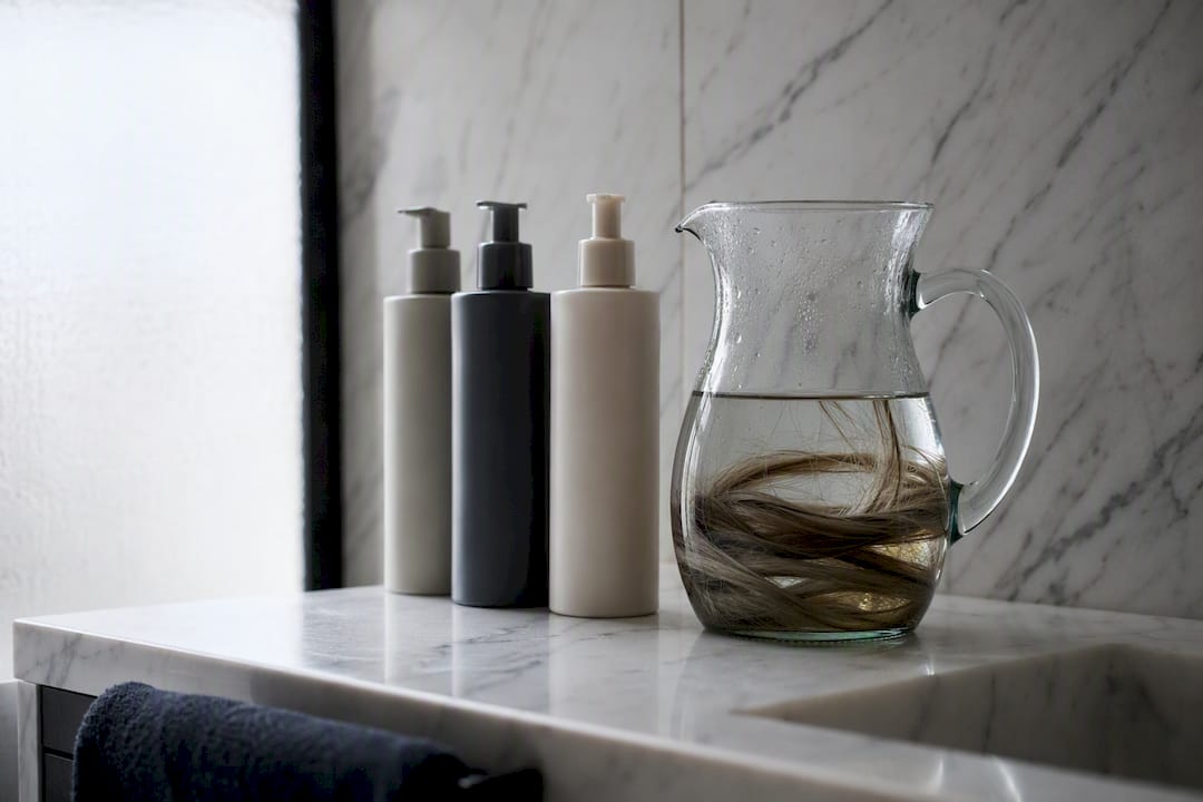 Shampoo and conditioner bottles with extension strands soaked
