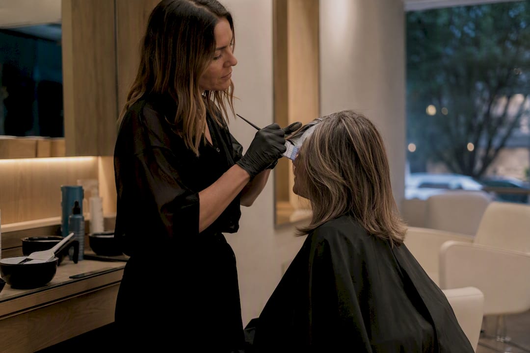 Stylist applying grey blending balayage