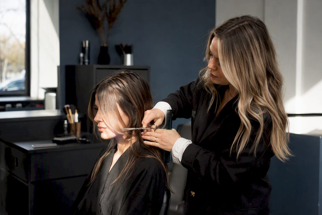 Stylist cutting face-framing layers