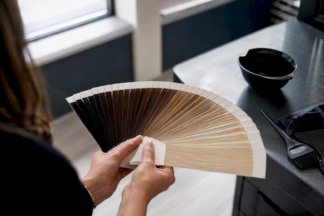 Stylists hands fanning hair colour levels 1 to 10