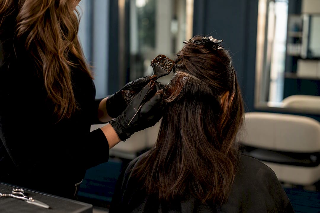 Hairstylist sectioning hair during consultation