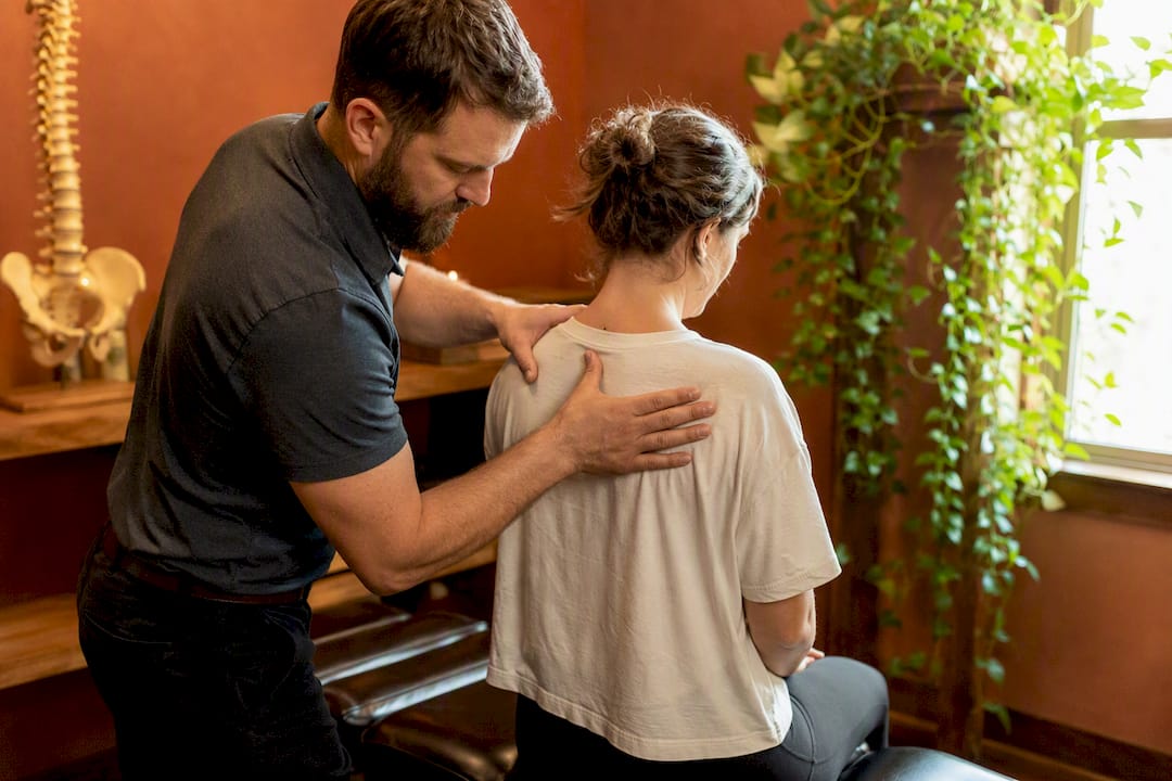 Chiropractor performing spinal adjustment