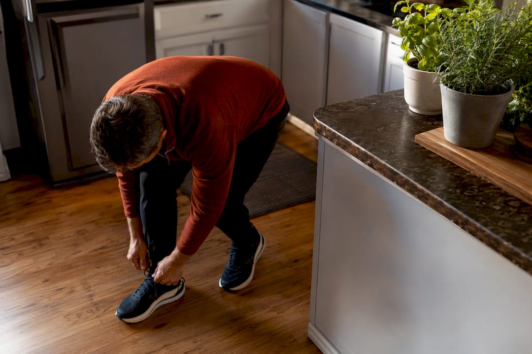 Person bending to tie shoe without pain