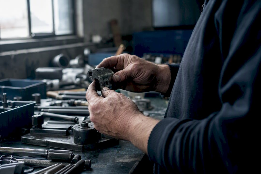 Close-up of worker’s hands gripping tool repetitively