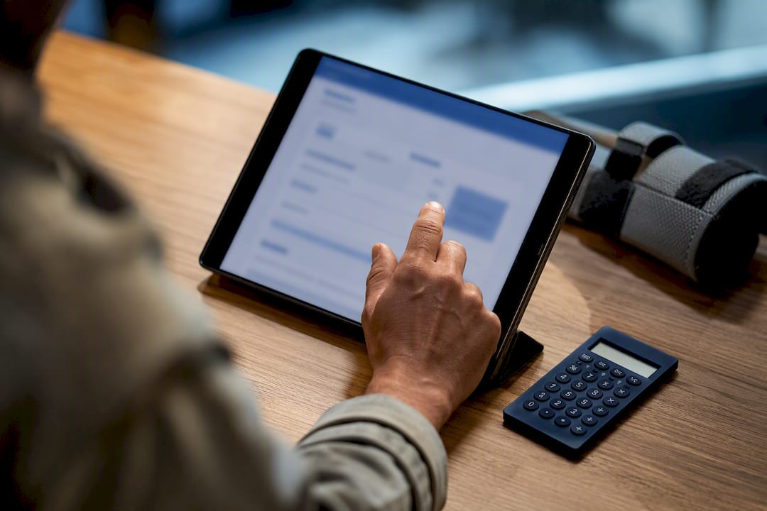 Worker reviewing a compensation estimate on tablet