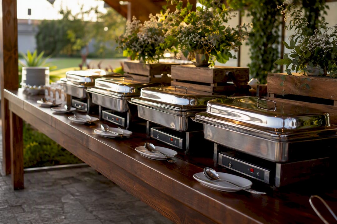 Buffet table with chafers and serving utensils