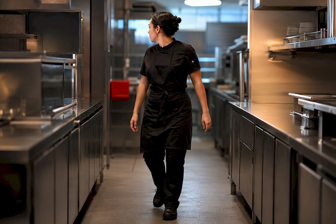 Operator testing commercial kitchen aisle width