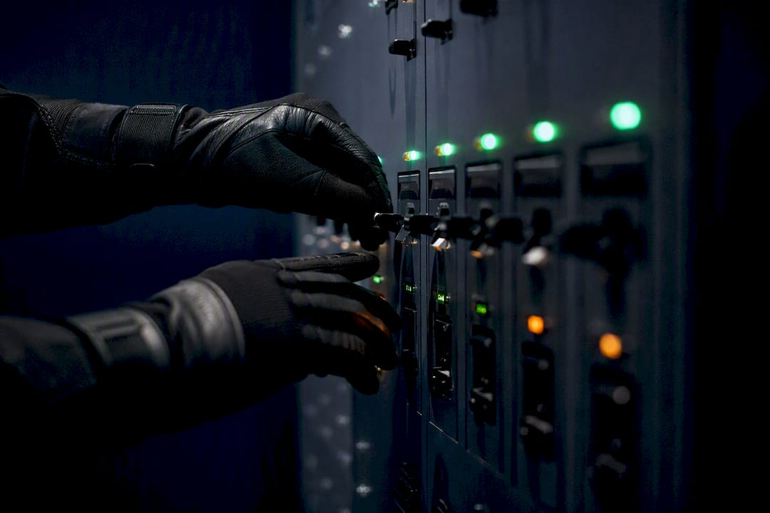 Hands toggling network access panel switches