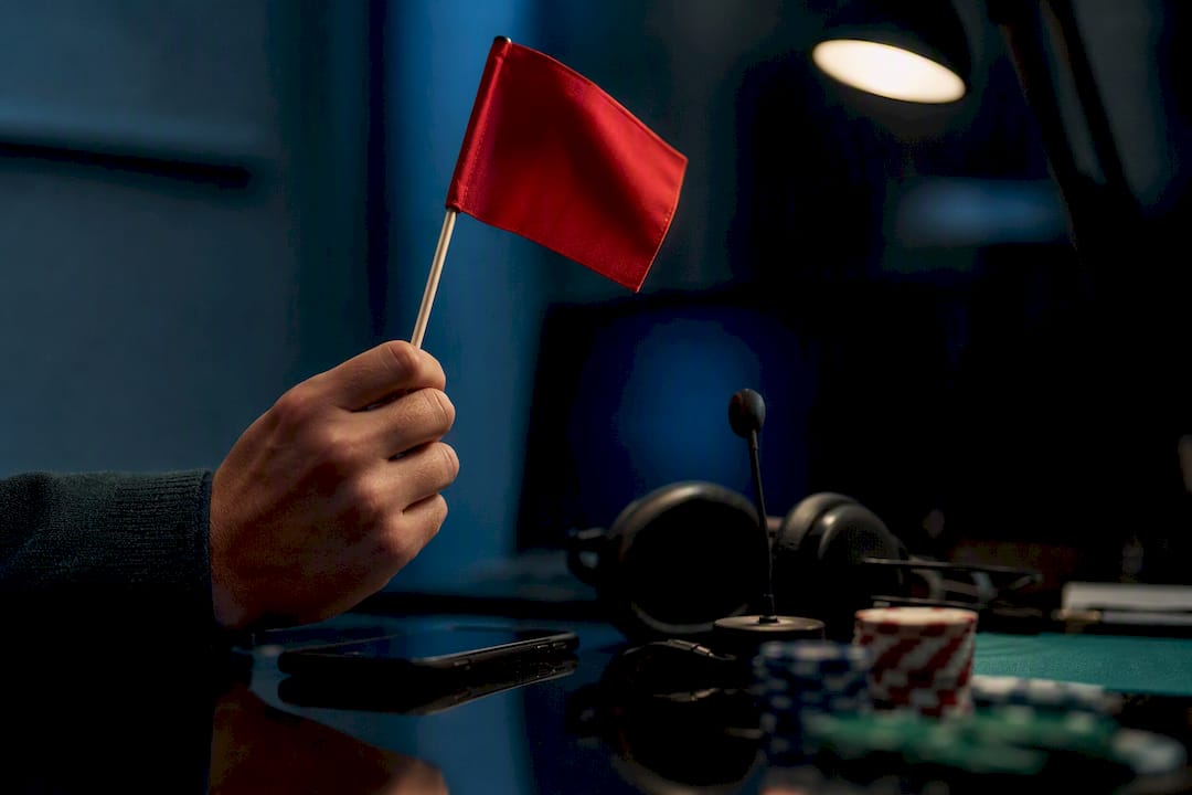 Hand holding caution flag above casino support devices