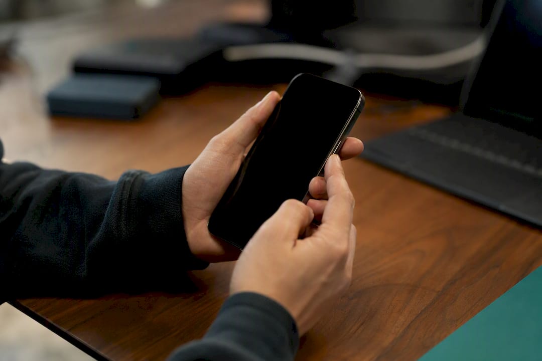 Hands manipulating communication device hardware