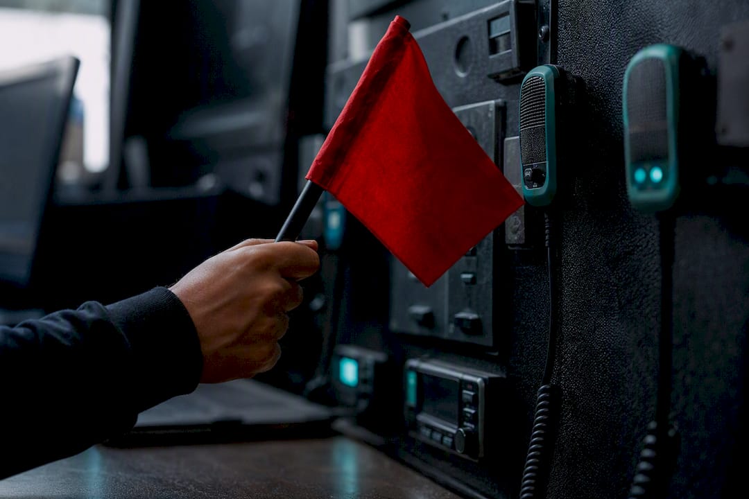 Hand holding alert flag in verification review