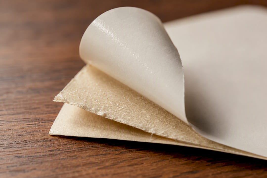Close-up showing pressure sensitive label adhesive and substrate