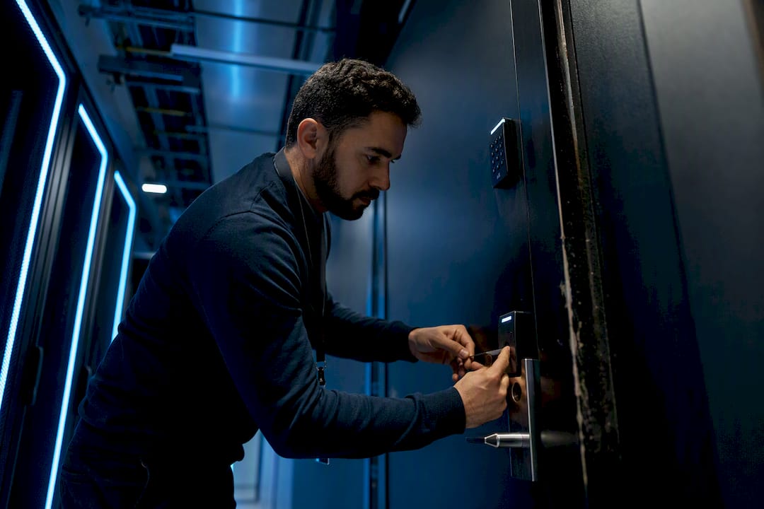 Technician inspecting locked server room door