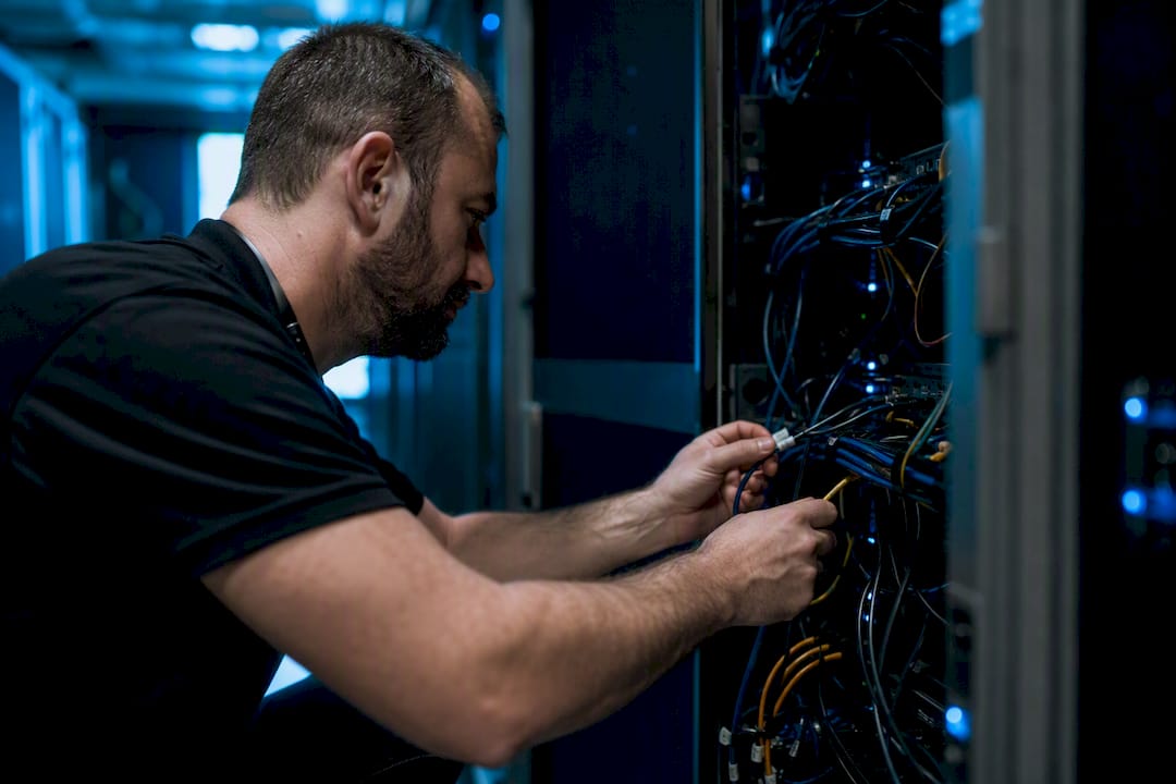 Technician managing server rack cable dependencies