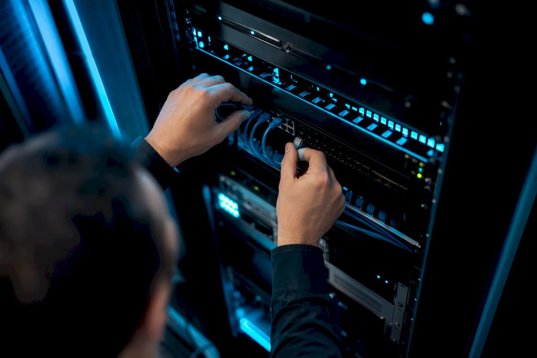 Technician unplugging network cable close-up